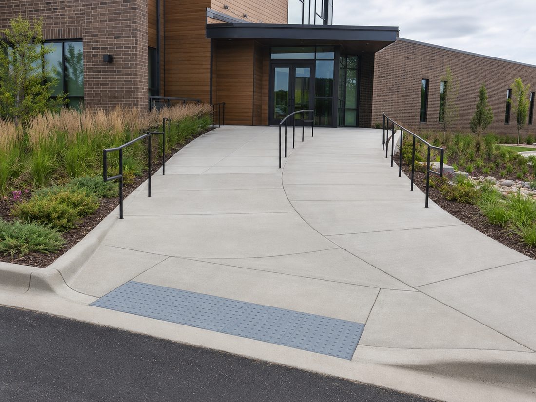 Commercial building entrance with ADA ramps, railings and detectable warning panels in Sioux Falls, SD